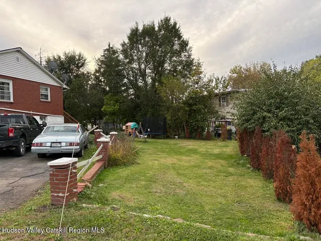 a backyard of a house with table and chairs