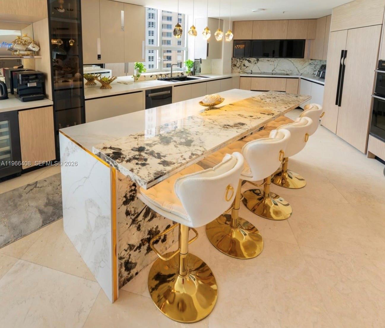 848 Brickell Key Drive, Unit 1601 Miami, FL 33131 - Photo 5 of 7 a kitchen with a sink and cabinets