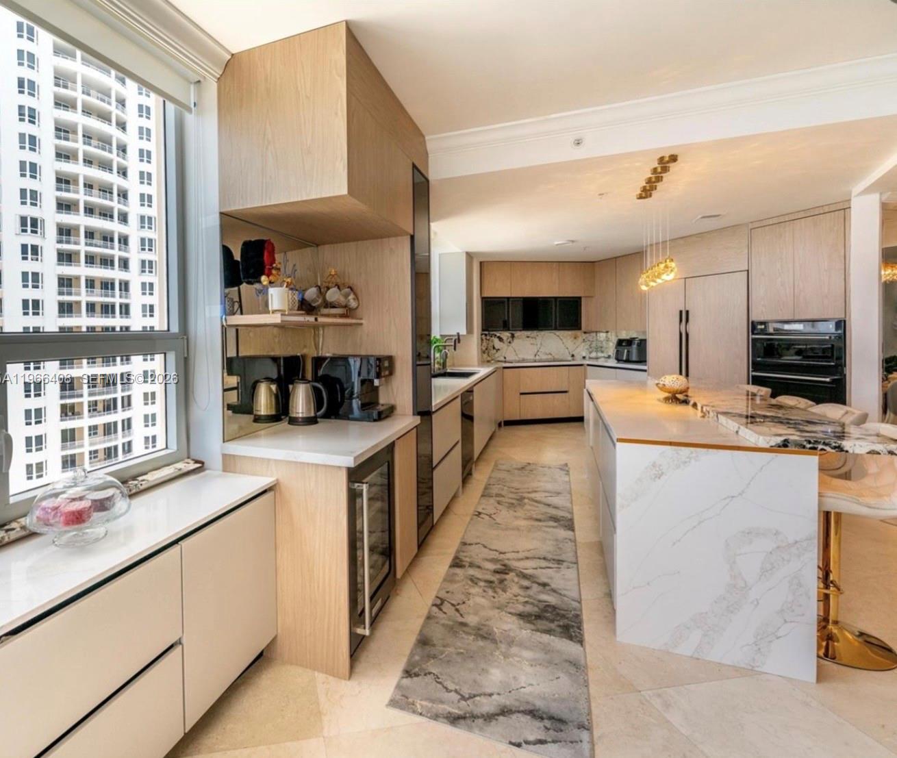 848 Brickell Key Drive, Unit 1601 Miami, FL 33131 - Photo 6 of 7 a large white kitchen with stainless steel appliances kitchen island granite countertop a large counter top stainless steel appliances and cabinets