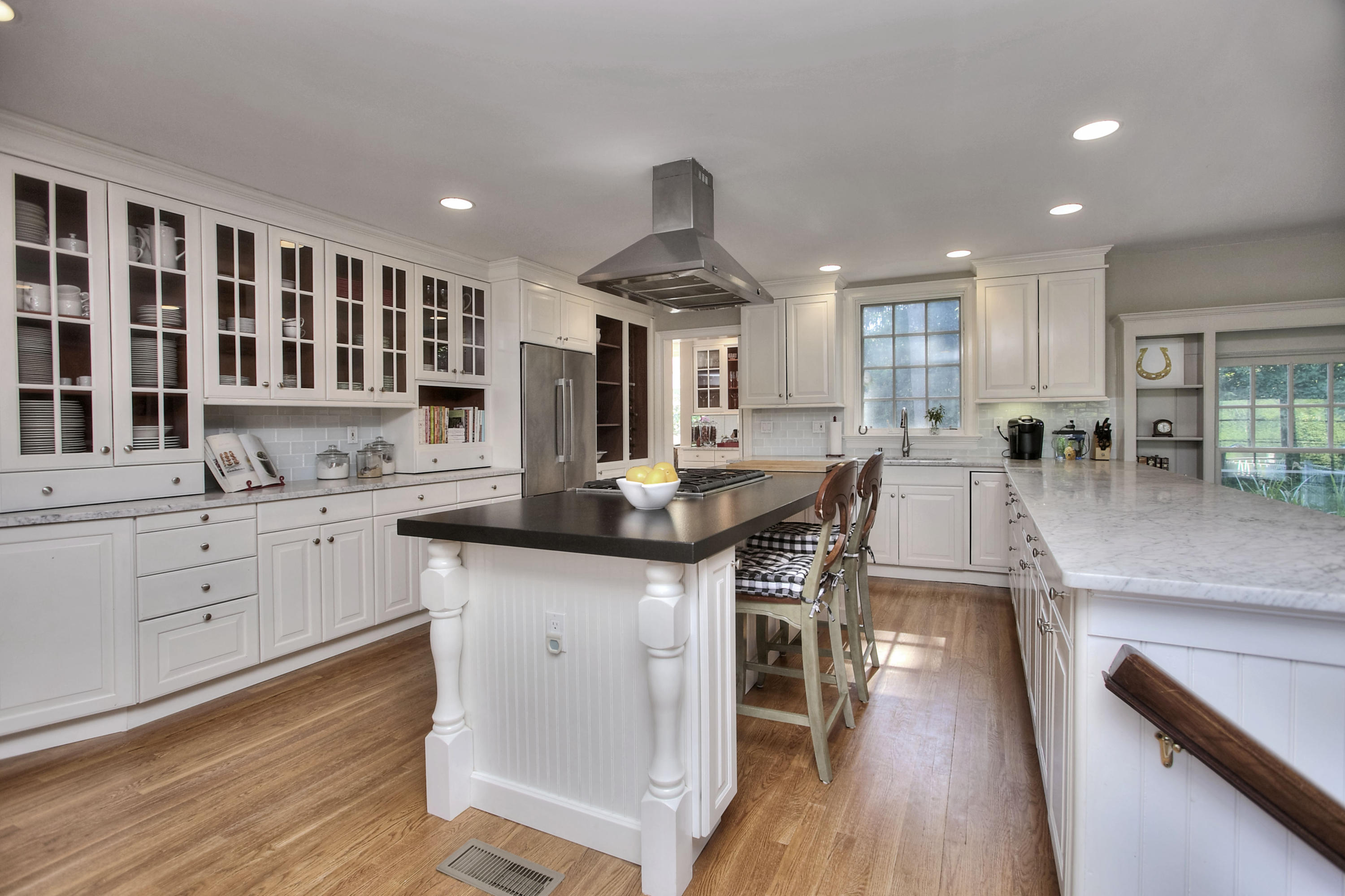 1335 Smith Ridge Road New Canaan, CT 06840 - Photo 11 of 42 a kitchen with granite countertop a stove a sink a dining table and chairs