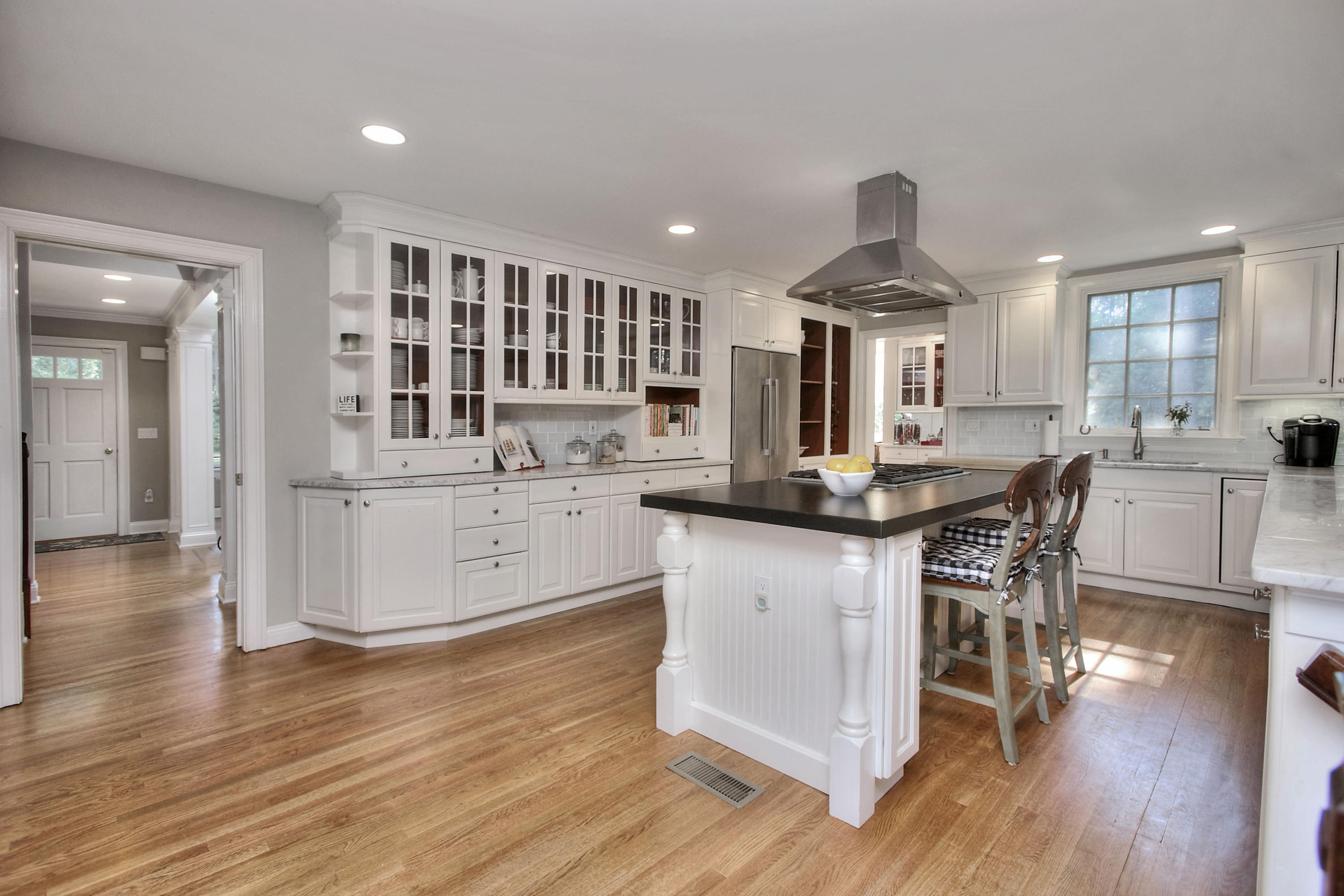 1335 Smith Ridge Road New Canaan, CT 06840 - Photo 12 of 42 a kitchen with stainless steel appliances kitchen island granite countertop a stove a sink a refrigerator and white cabinets with wooden floor