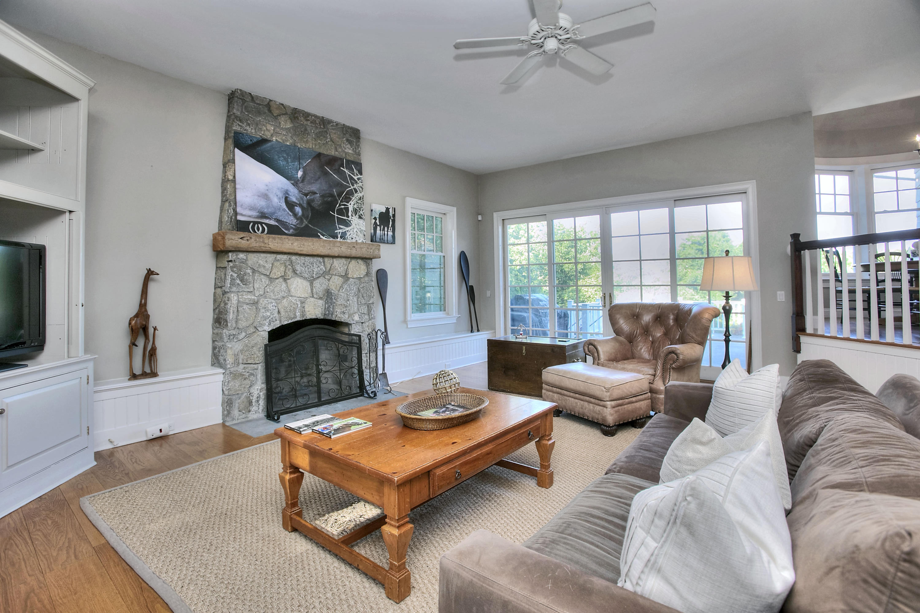 1335 Smith Ridge Road New Canaan, CT 06840 - Photo 16 of 42 a living room with furniture a flat screen tv and a fireplace