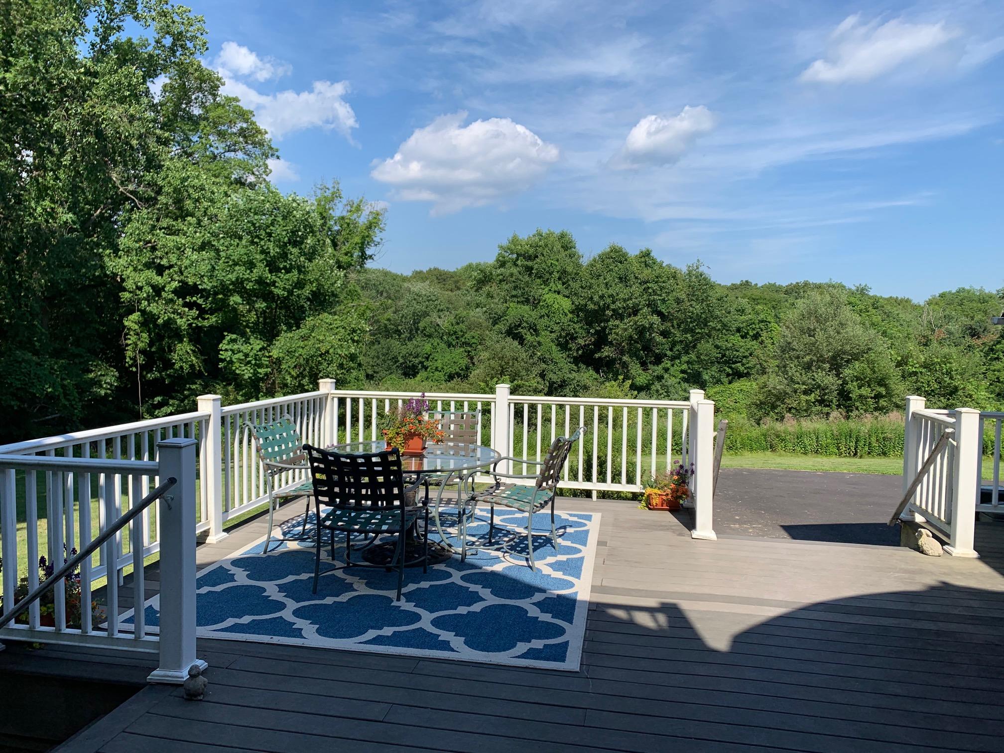 1335 Smith Ridge Road New Canaan, CT 06840 - Photo 18 of 42 a view of a chair and tables on the roof deck