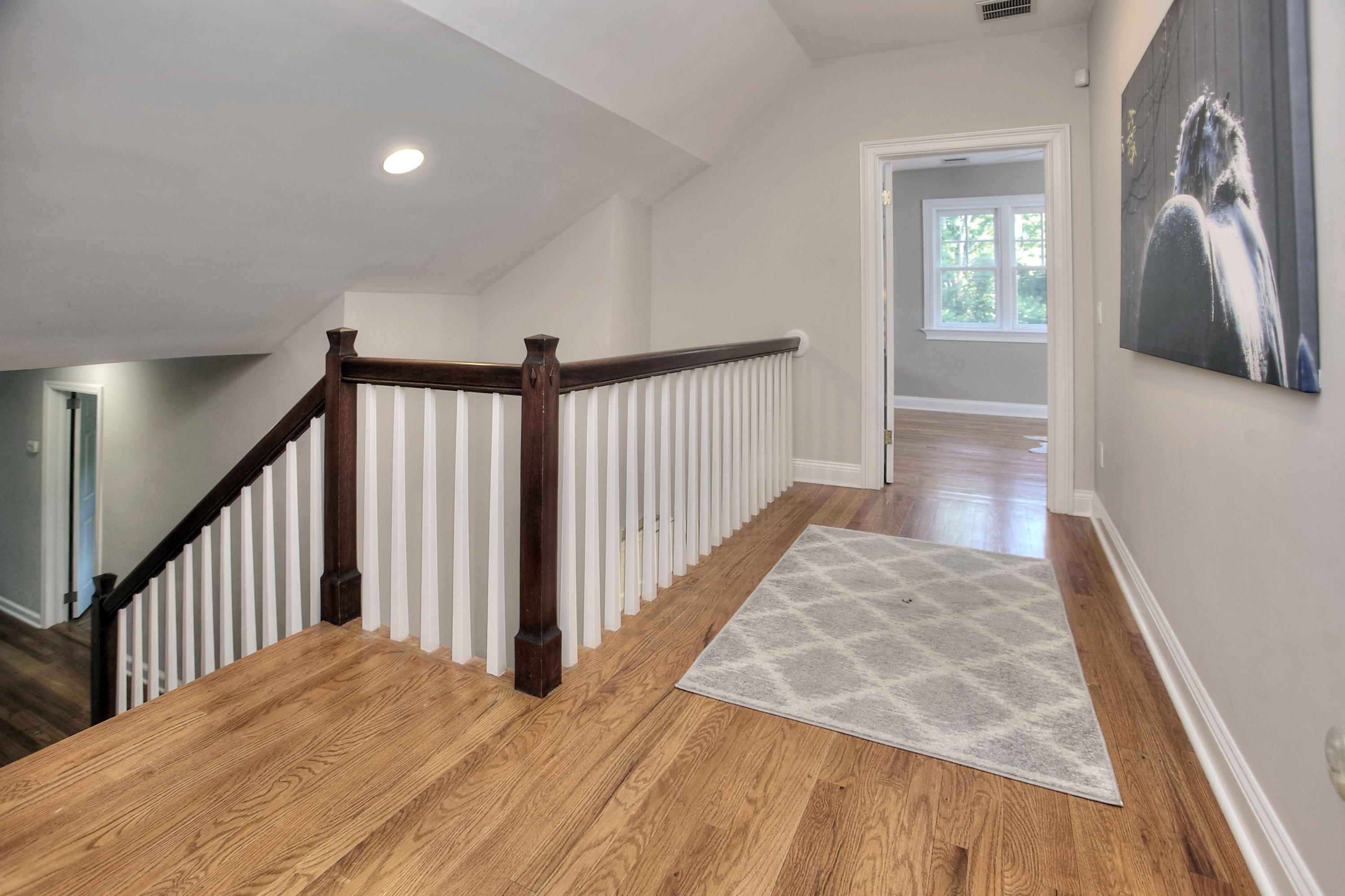 1335 Smith Ridge Road New Canaan, CT 06840 - Photo 23 of 42 a view of a hallway view with wooden floor and staircase