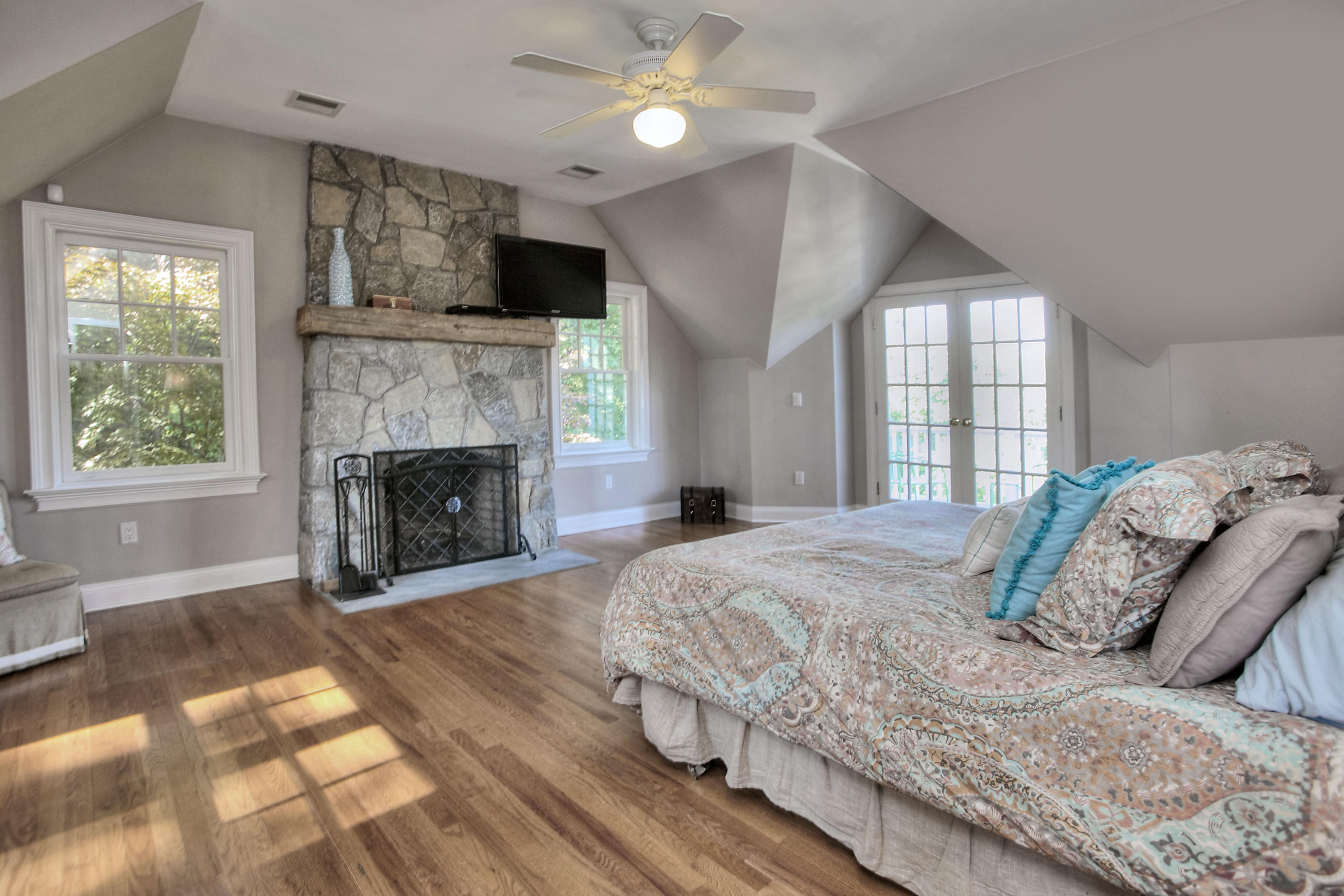 1335 Smith Ridge Road New Canaan, CT 06840 - Photo 25 of 42 a bedroom with a large bed and a fireplace