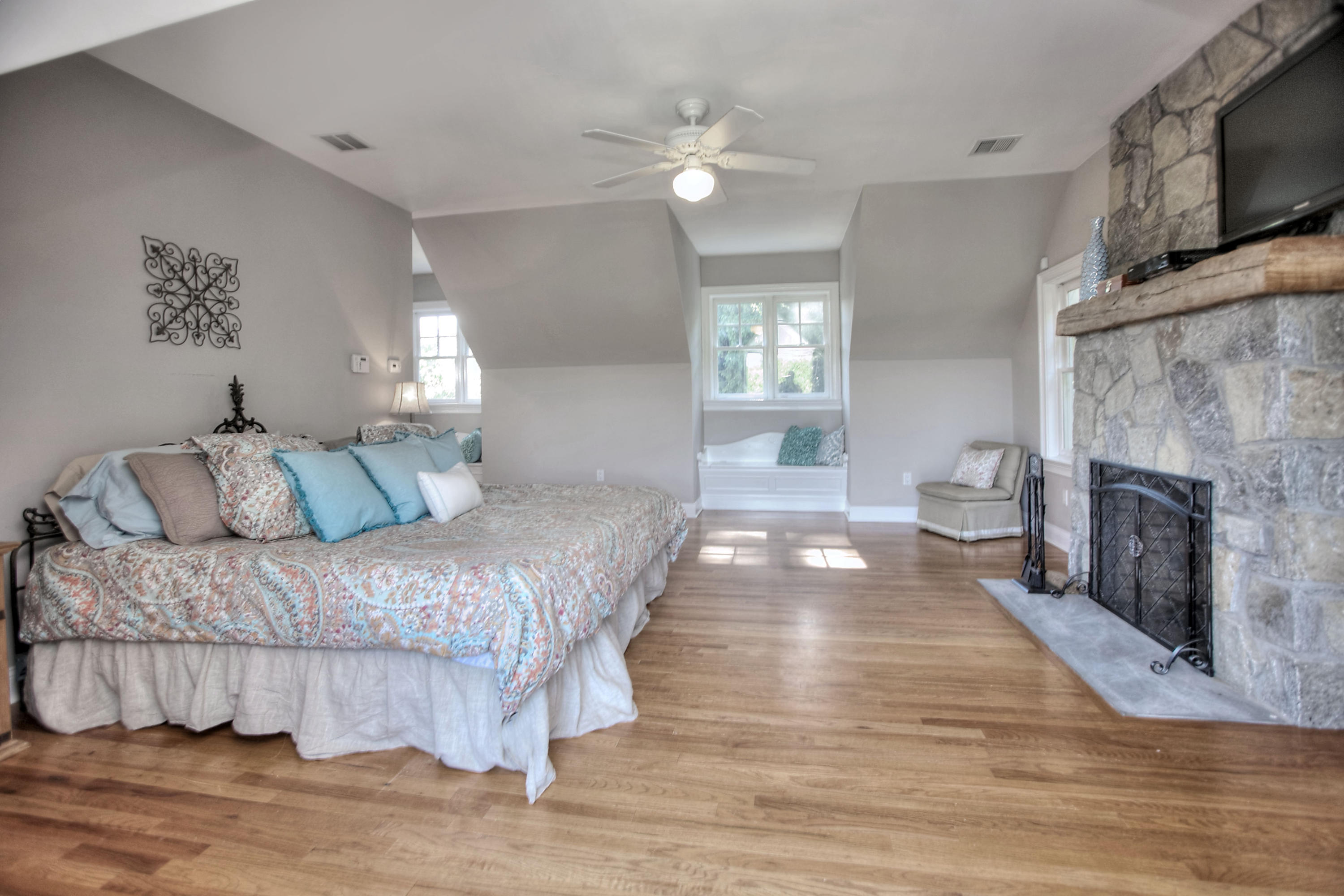 1335 Smith Ridge Road New Canaan, CT 06840 - Photo 26 of 42 a spacious bedroom with a bed and a fireplace