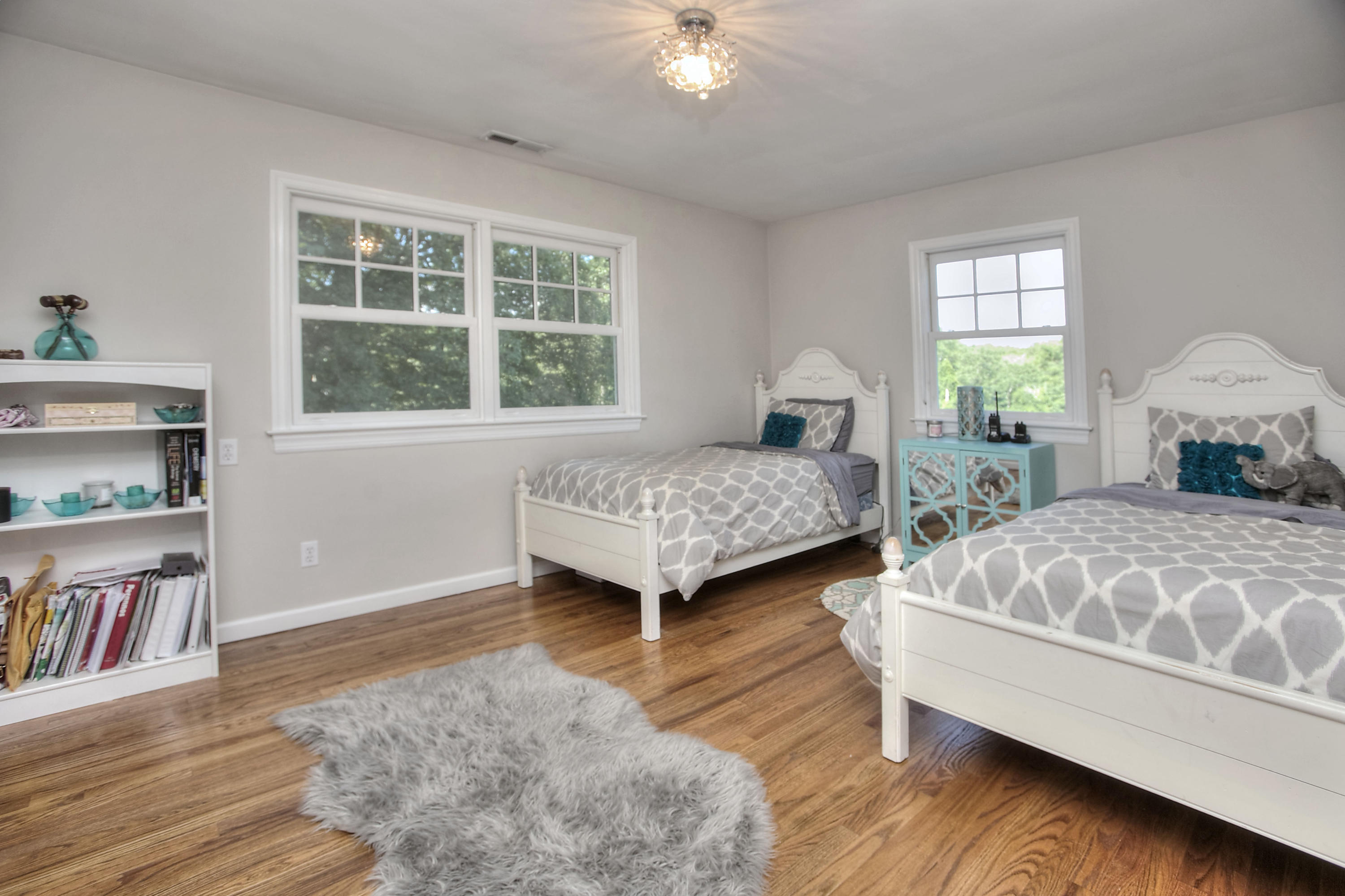 1335 Smith Ridge Road New Canaan, CT 06840 - Photo 35 of 42 a bedroom with a bed a dresser and a window