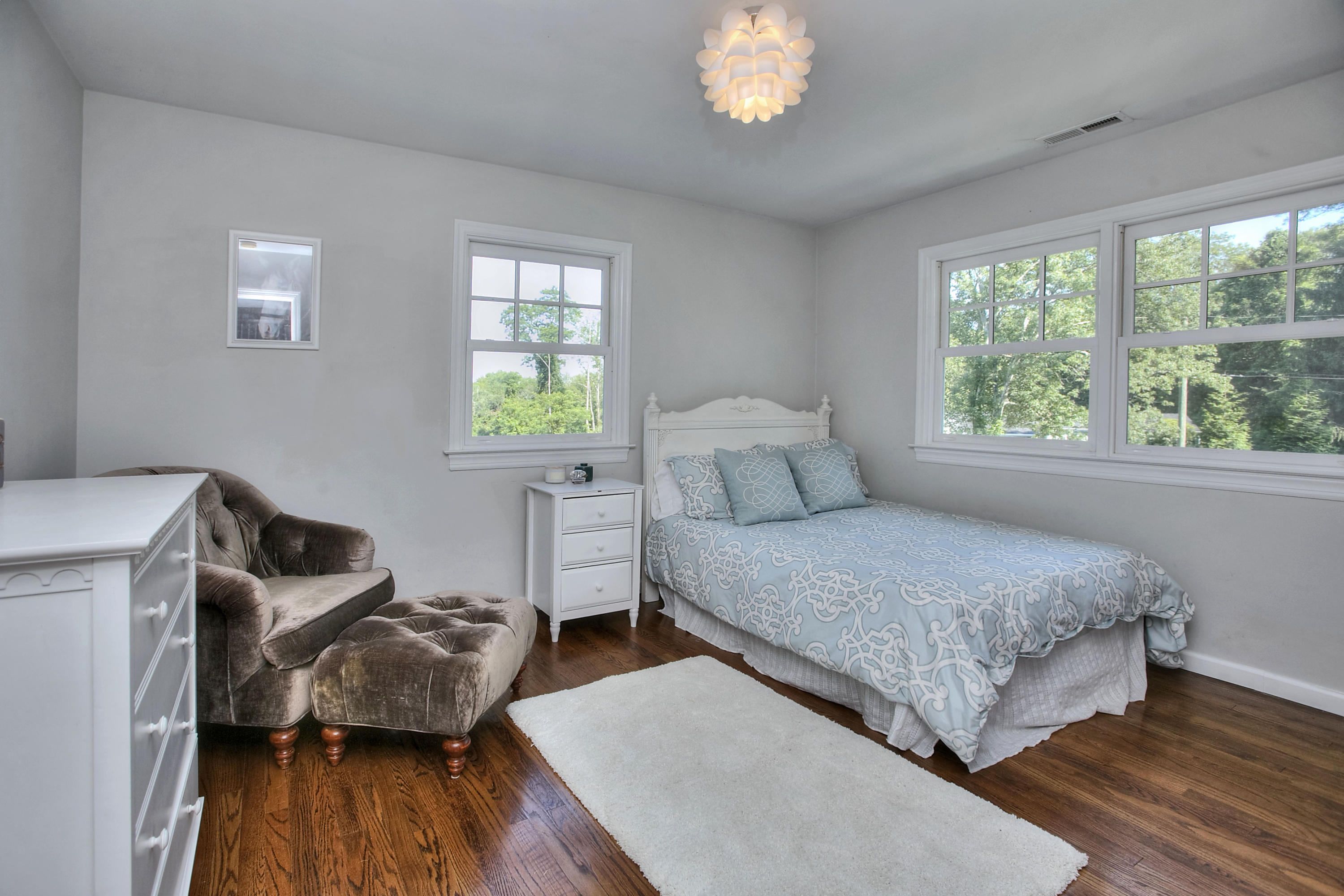1335 Smith Ridge Road New Canaan, CT 06840 - Photo 37 of 42 a bedroom with a bed and wooden floor