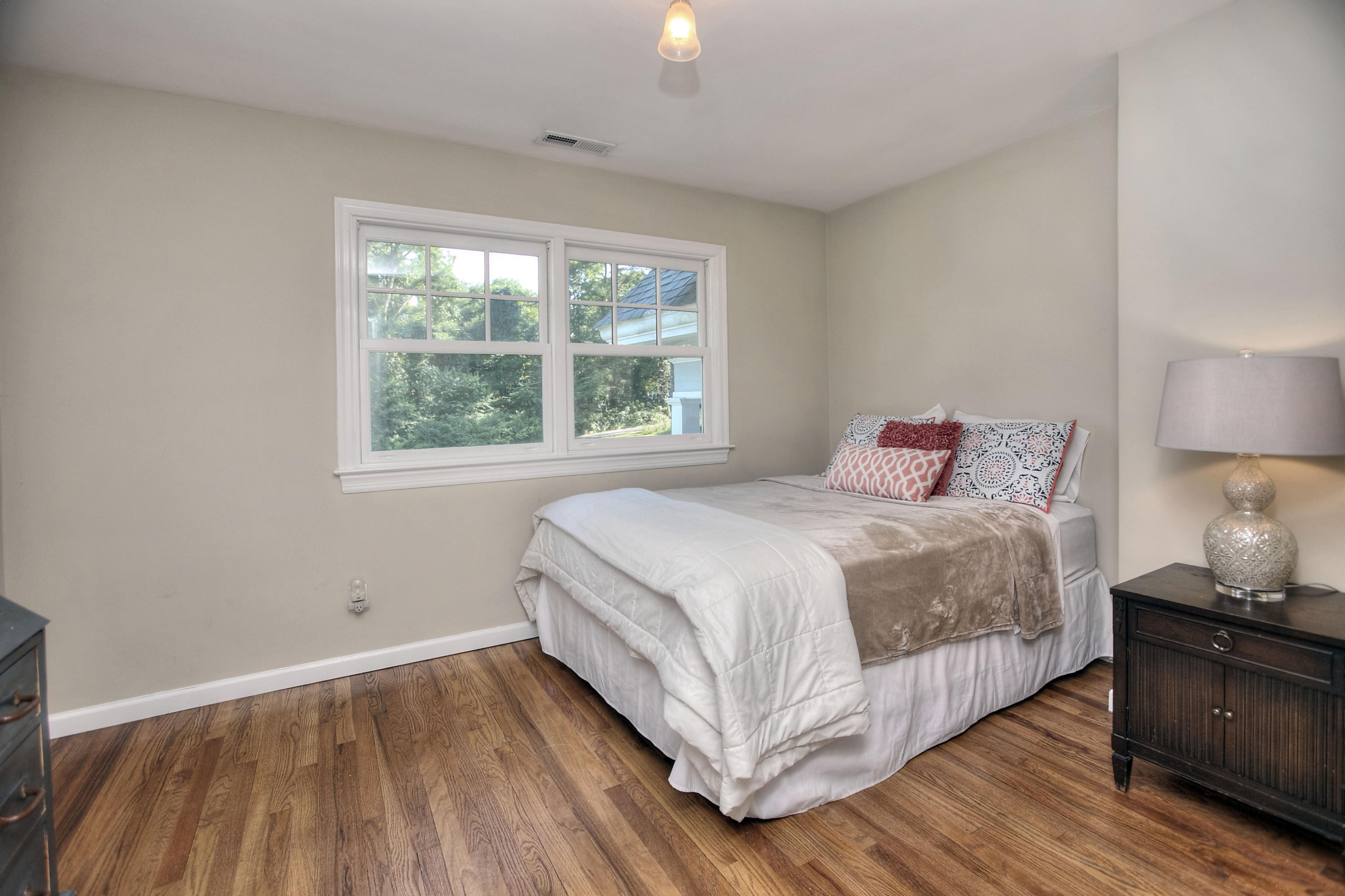 1335 Smith Ridge Road New Canaan, CT 06840 - Photo 38 of 42 a bedroom with a bed and wooden floor