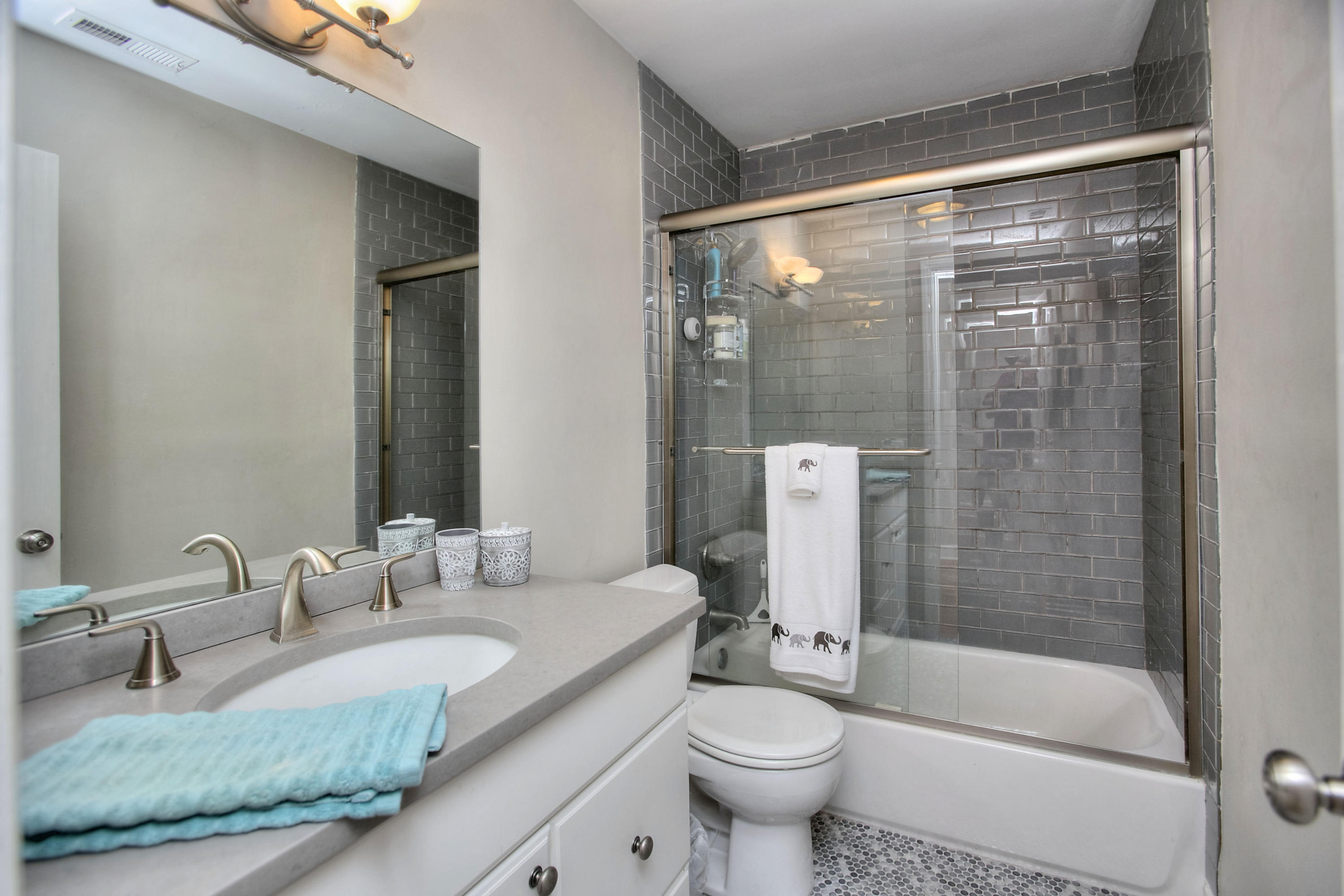 1335 Smith Ridge Road New Canaan, CT 06840 - Photo 39 of 42 a bathroom with a granite countertop sink mirror toilet and bathtub