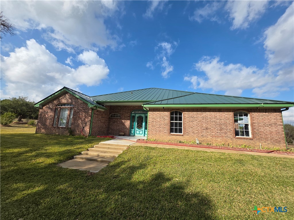 853 County Road 4390 Kempner, TX 76539 - Photo 3 of 43 a front view of house with yard and trees in the background