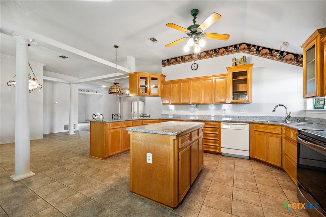 853 County Road 4390 Kempner, TX 76539 - Photo 32 of 43 a kitchen with stainless steel appliances granite countertop a sink counter space cabinetry and a chandelier