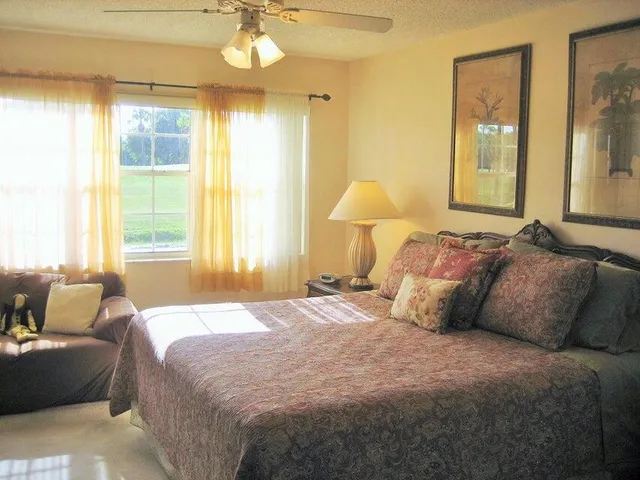 a bedroom with bed and a window