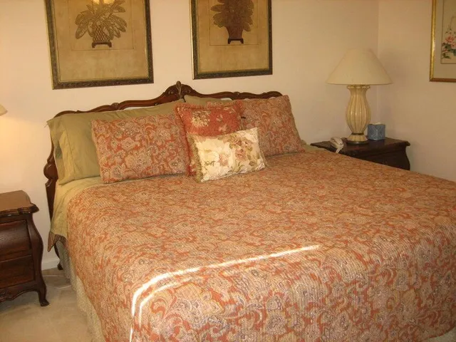 a large bed sitting in a bedroom next to a wall