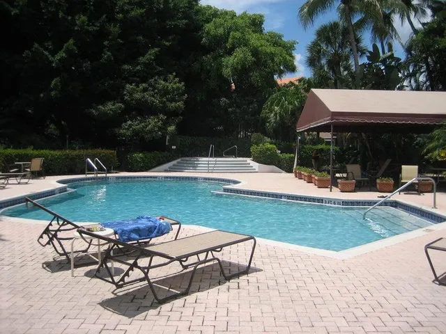 a view of a swimming pool and lounge chairs