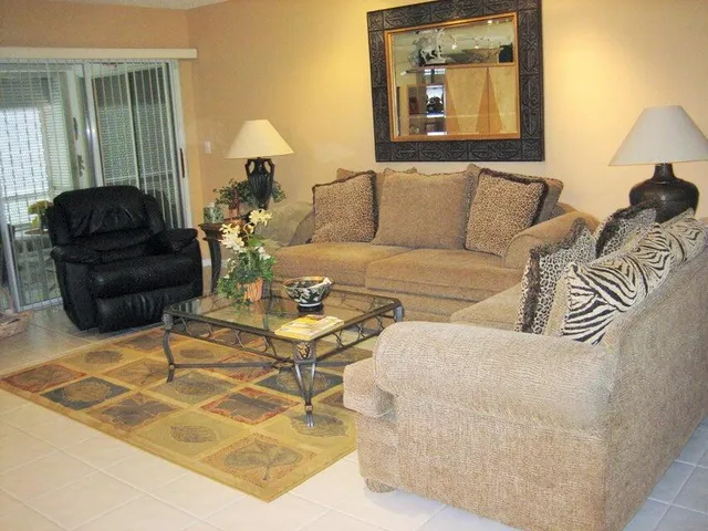 a living room with furniture and a lamp