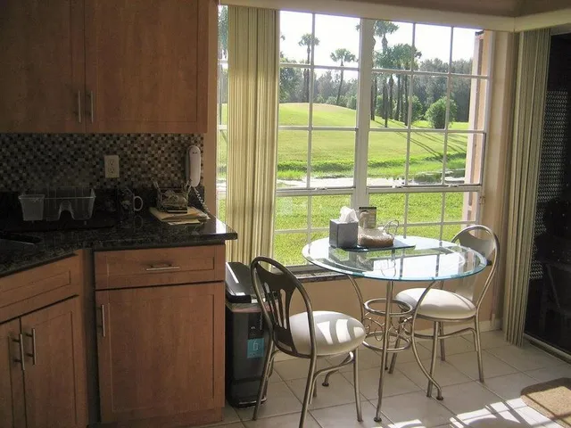 a view of a dining room with furniture window and outside view