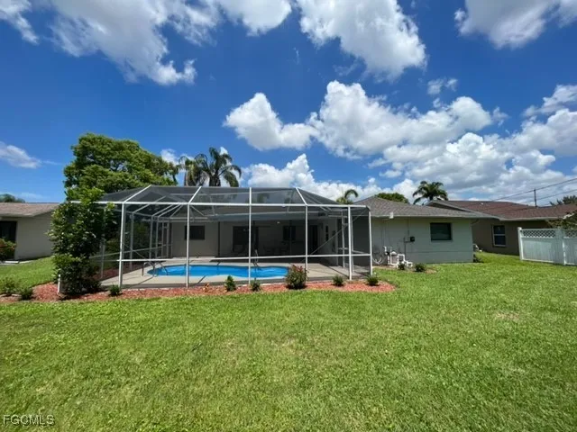 a view of a house with backyard and porch