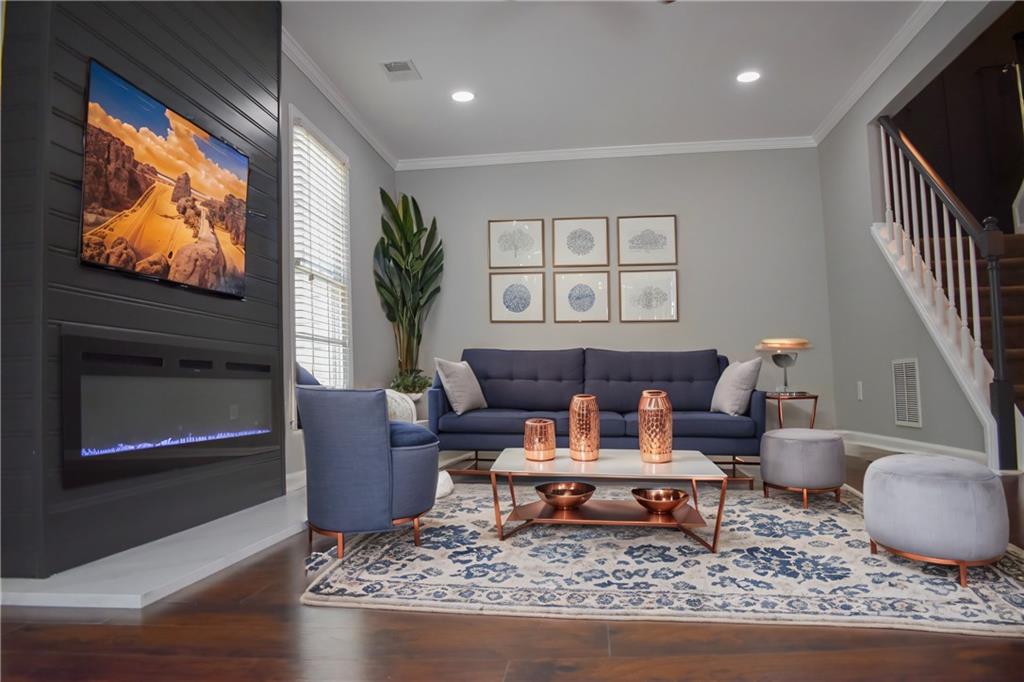 131 Willow Stream Court Roswell, GA 30076 - Photo 11 of 25 a living room with furniture and a flat screen tv