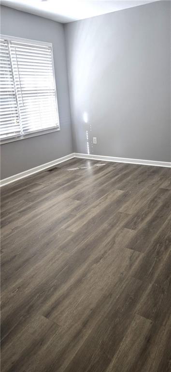 131 Willow Stream Court Roswell, GA 30076 - Photo 19 of 25 an empty room with wooden floor and windows