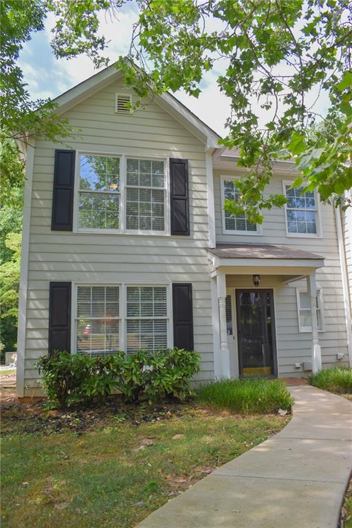 131 Willow Stream Court Roswell, GA 30076 - Photo 3 of 25 a view of a brick house with a large windows stairs and a large tree