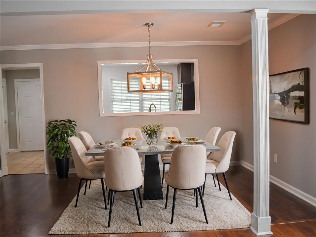 131 Willow Stream Court Roswell, GA 30076 - Photo 5 of 25 a view of a dining room with furniture wooden floor and a chandelier