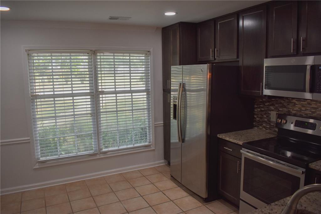 131 Willow Stream Court Roswell, GA 30076 - Photo 7 of 25 a kitchen with a refrigerator and a stove