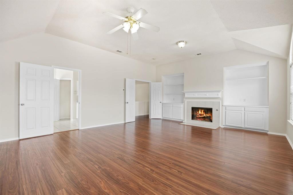 433 Spring Air Drive Allen, TX 75002 - Photo 15 of 27 a view of empty room with wooden floor and fireplace
