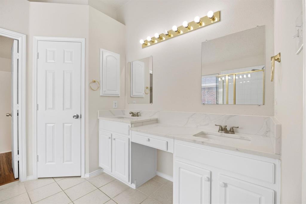 433 Spring Air Drive Allen, TX 75002 - Photo 17 of 27 a bathroom with a sink vanity and a mirror