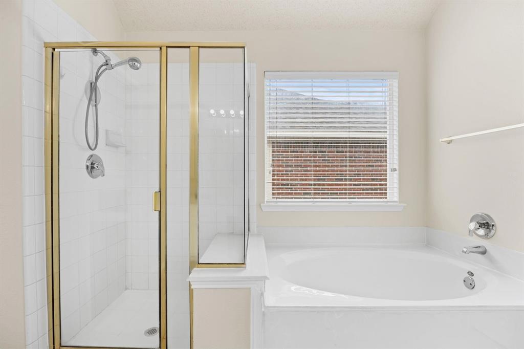 433 Spring Air Drive Allen, TX 75002 - Photo 18 of 27 a bathroom with a bathtub and a shower