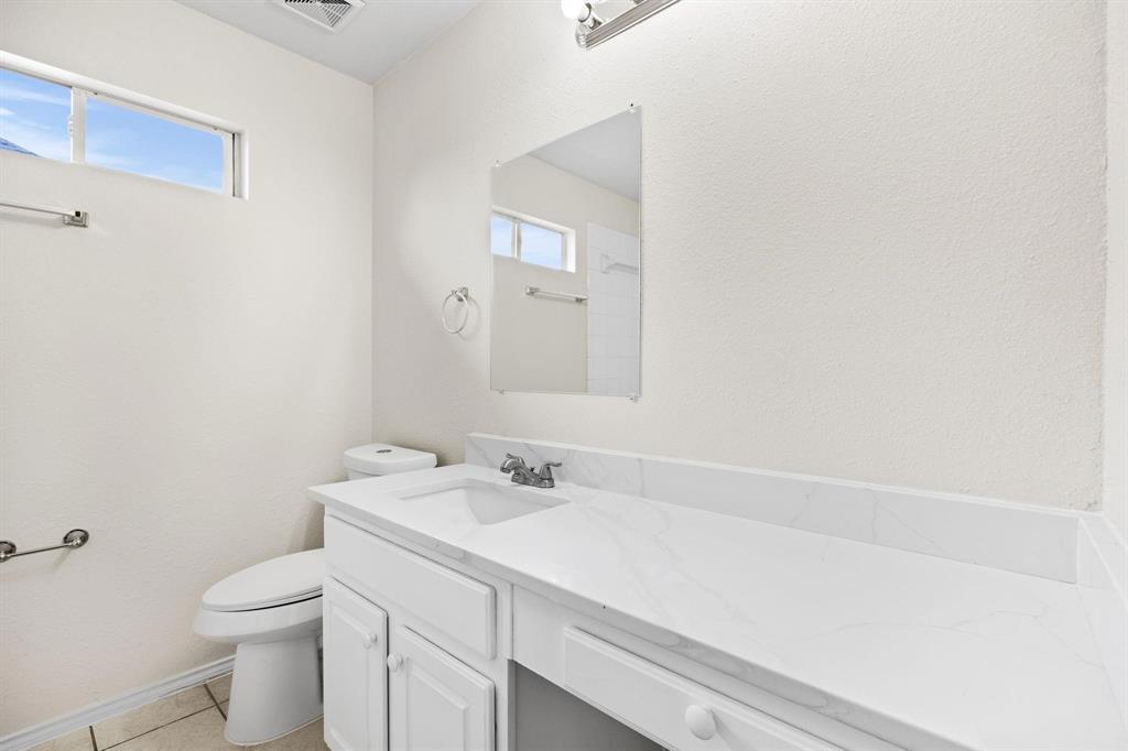 433 Spring Air Drive Allen, TX 75002 - Photo 21 of 27 a bathroom with a sink a toilet and a mirror