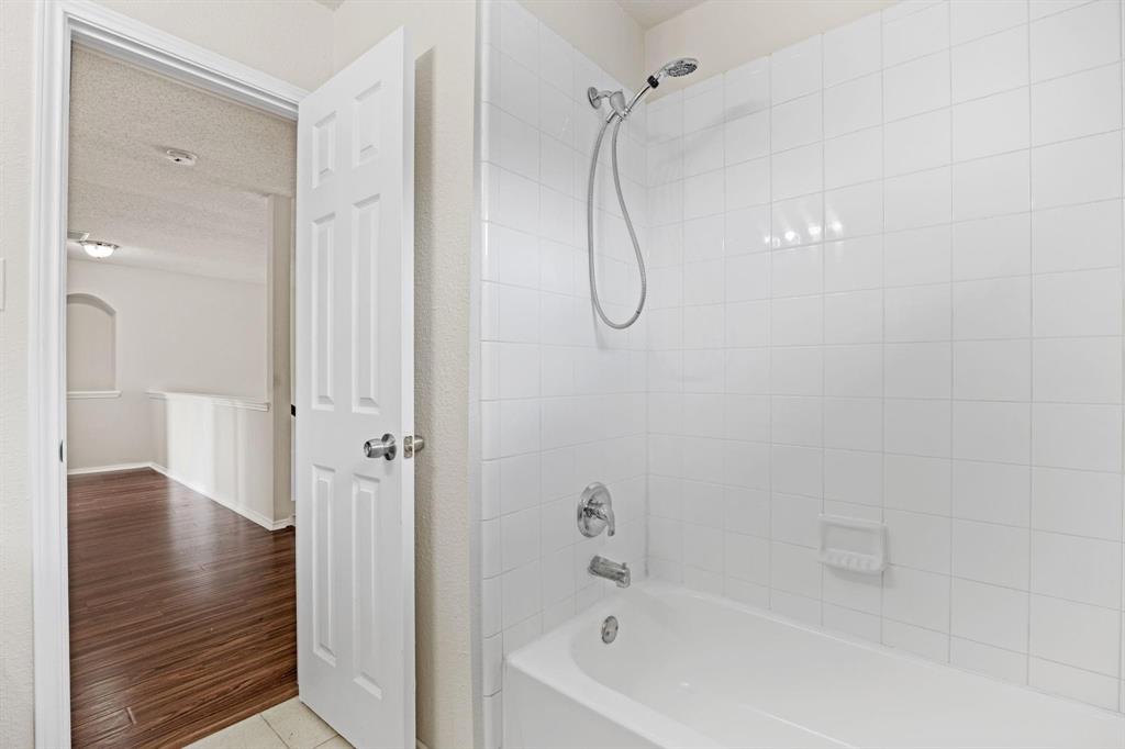 433 Spring Air Drive Allen, TX 75002 - Photo 22 of 27 a bathroom with a bathtub and shower