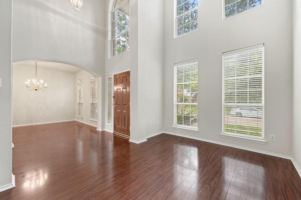 433 Spring Air Drive Allen, TX 75002 - Photo 4 of 27 a view of an empty room with wooden floor and a window