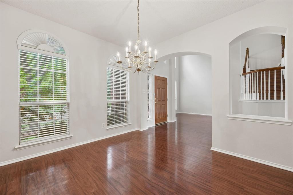 433 Spring Air Drive Allen, TX 75002 - Photo 5 of 27 a view of an empty room with wooden floor and a window