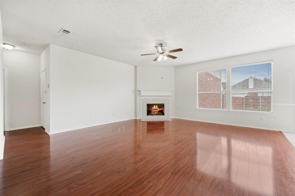 433 Spring Air Drive Allen, TX 75002 - Photo 7 of 27 a view of an empty room with a window and wooden floor