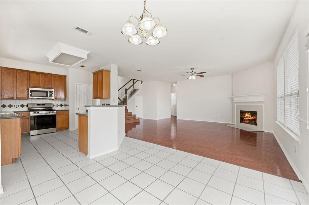 433 Spring Air Drive Allen, TX 75002 - Photo 8 of 27 a kitchen with stainless steel appliances granite countertop a refrigerator a stove top oven a sink dishwasher and a stove with wooden floor