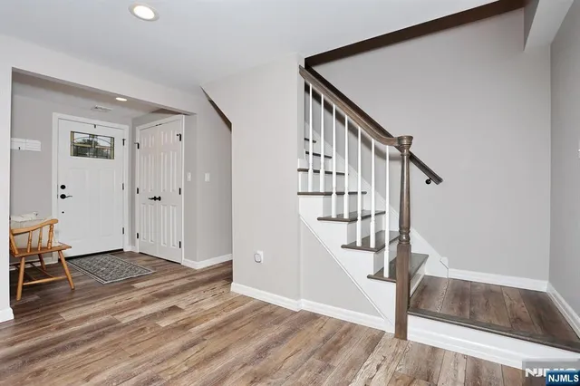 a view of a livingroom with a ceiling fan and wooden floor
