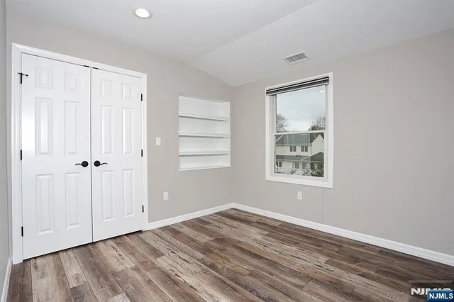 a view of a room with wooden floor