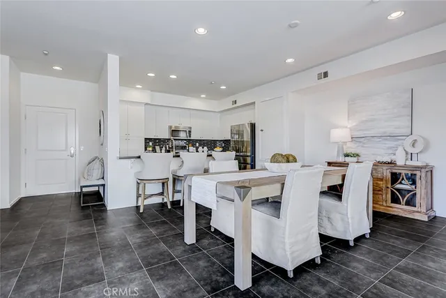 a large white kitchen with lots of counter space and furniture