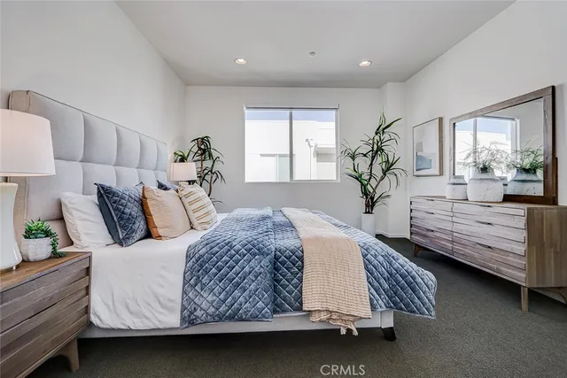a bedroom with a bed window and couch