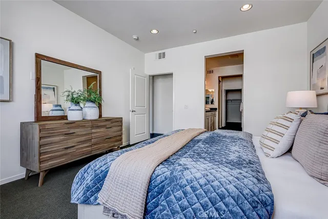 a spacious bedroom with a bed and a couch