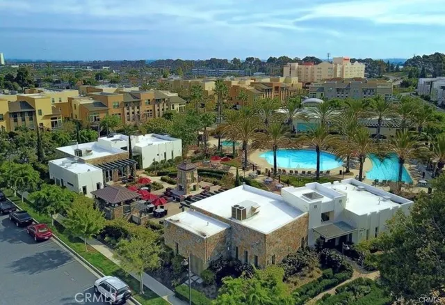 an aerial view of residential houses with outdoor space and ocean view