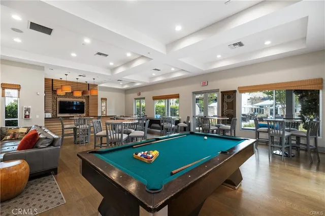 a living room with furniture a flat screen tv and a table
