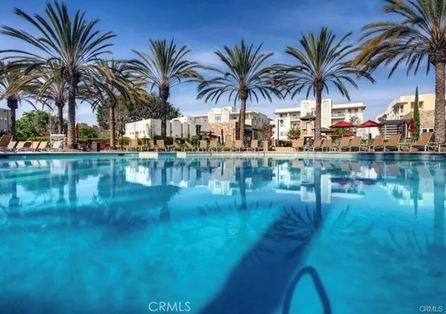a view of swimming pool with outdoor seating and lake view
