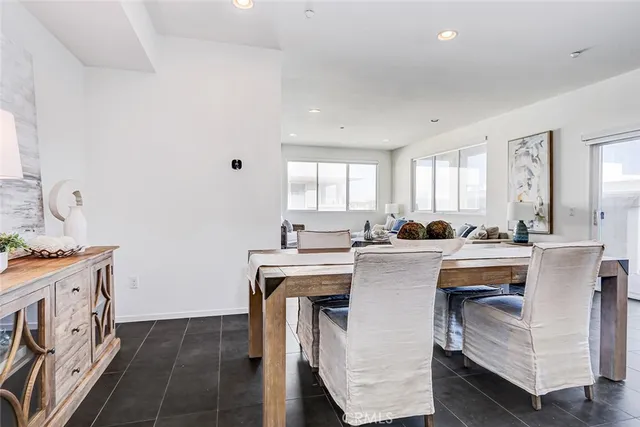 a kitchen with white cabinets and sink