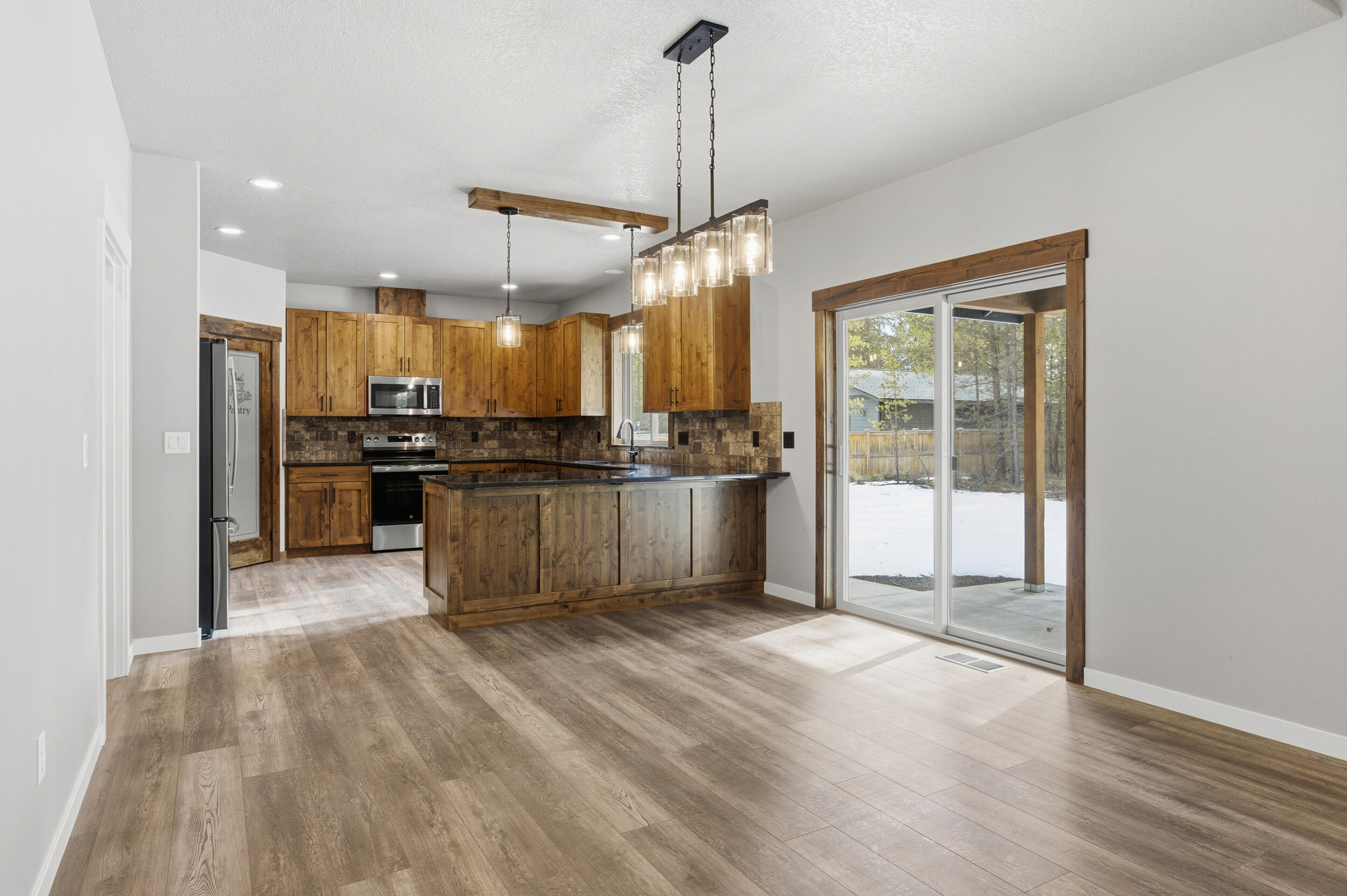 16083 Dyke Road, Unit 9 La Pine, OR 97739 - Photo 8 of 53 a kitchen with stainless steel appliances granite countertop a refrigerator and a stove top oven