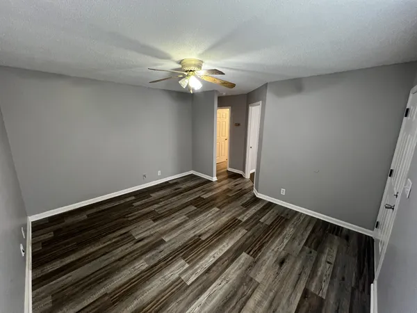a view of room with a ceiling fan and window