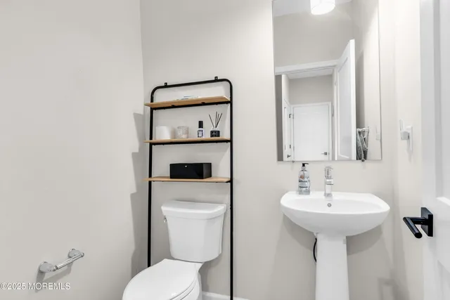 a bathroom with a sink toilet and mirror