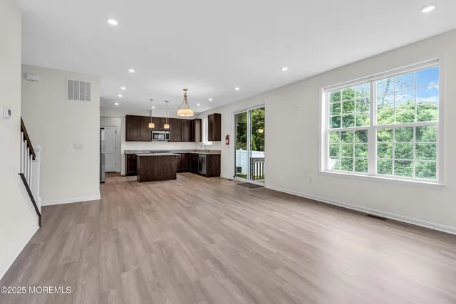 a view of kitchen and window with wooden floor