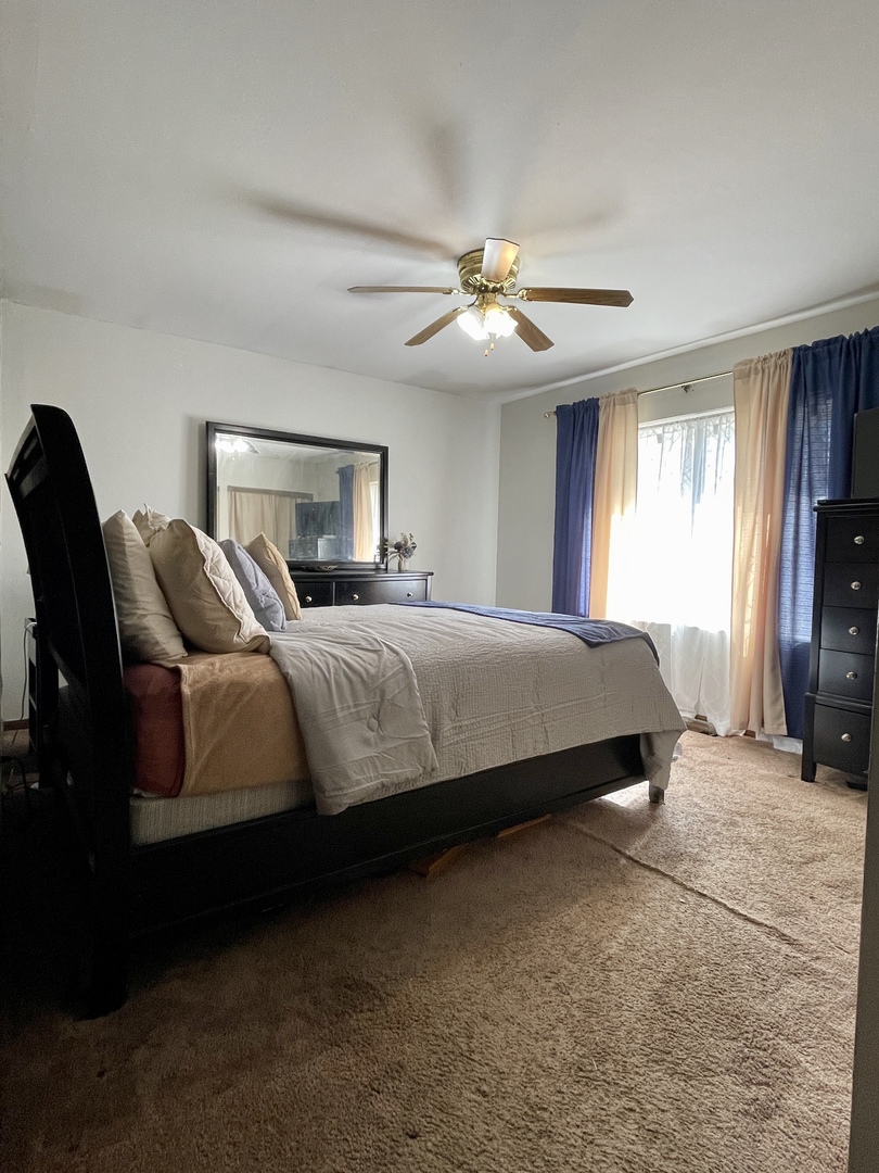3406 Seine Court Hazel Crest, IL 60429 - Photo 16 of 26 a bedroom with a bed and a ceiling fan